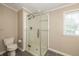 Modern bathroom features a glass enclosed shower with white subway tile and contemporary fixtures at 1114 E 234Th St, Sheridan, IN 46069