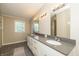 Bright bathroom boasts double sinks, gray countertops and tile floor and lots of lighting at 1114 E 234Th St, Sheridan, IN 46069