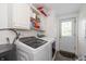 Laundry room features modern Samsung washer and dryer, storage cabinets, and exterior door at 1114 E 234Th St, Sheridan, IN 46069