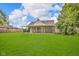Expansive backyard with covered patio, well-kept lawn and lush landscaping at 1141 N Shadeland Ave, Indianapolis, IN 46219