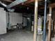 Unfinished basement area with a water heater and support beams at 1141 N Shadeland Ave, Indianapolis, IN 46219