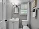 Clean bathroom featuring white fixtures and a window with natural light at 1141 N Shadeland Ave, Indianapolis, IN 46219