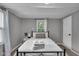 Cozy bedroom with a black bed frame, fresh white linens, and a stack of towels at 1141 N Shadeland Ave, Indianapolis, IN 46219
