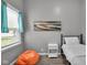 Bright, colorful bedroom featuring a beanbag chair, art and a comfortable bed at 1141 N Shadeland Ave, Indianapolis, IN 46219