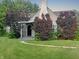 Charming home with a well-manicured lawn, mature trees, and inviting front porch at 1141 N Shadeland Ave, Indianapolis, IN 46219