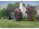 Inviting front exterior with lush landscaping, walkway, and a classic architectural style at 1141 N Shadeland Ave, Indianapolis, IN 46219