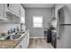 Well-lit kitchen features stainless steel appliances, a double sink, and granite countertops at 1141 N Shadeland Ave, Indianapolis, IN 46219