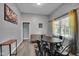 Inviting living area features a dining table, sofa, and a window for natural light at 1141 N Shadeland Ave, Indianapolis, IN 46219