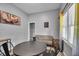 The spacious living area features a dining table, sofa, and natural light from the window at 1141 N Shadeland Ave, Indianapolis, IN 46219