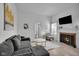 Bright living room with a fireplace, neutral tones, and modern furnishings at 1141 N Shadeland Ave, Indianapolis, IN 46219