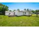 Spacious backyard with a deck, lawn, and a detached garage, great for outdoor activities at 120 Hoss Rd, Indianapolis, IN 46217