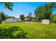 Expansive backyard featuring a fire pit, storage shed, and plenty of green space at 120 Hoss Rd, Indianapolis, IN 46217