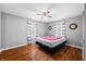 Bedroom with hardwood floors, ceiling fan, and striped curtains at 120 Hoss Rd, Indianapolis, IN 46217