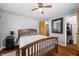 Primary bedroom with hardwood floors, ceiling fan and ensuite bathroom at 120 Hoss Rd, Indianapolis, IN 46217
