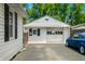 Detached garage features white siding, a traditional door, and parking space on a paved driveway at 120 Hoss Rd, Indianapolis, IN 46217