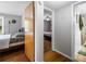 Hallway view of bedrooms with hardwood floors and neutral paint at 120 Hoss Rd, Indianapolis, IN 46217