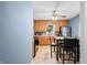 Well-lit kitchen featuring oak cabinets, dining table, and stainless steel refrigerator at 120 Hoss Rd, Indianapolis, IN 46217