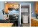 View of laundry room from kitchen, features overhead cabinets and appliances at 120 Hoss Rd, Indianapolis, IN 46217