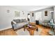 Cozy living room with hardwood floors, comfortable sofa, chair, and area rug at 120 Hoss Rd, Indianapolis, IN 46217