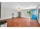 Large living room with hardwood floors, a ceiling fan, and an adjacent blue door at 120 Hoss Rd, Indianapolis, IN 46217