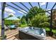 Backyard area with a hot tub and outdoor dining set under a pergola at 1217 Old Vines Trl, Greenwood, IN 46143