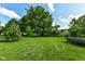 Lush green backyard with well maintained lawn and a trampoline at 1217 Old Vines Trl, Greenwood, IN 46143