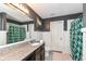 This bathroom features granite counters, a large mirror and green shower curtains at 1217 Old Vines Trl, Greenwood, IN 46143