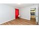 Well-lit bedroom features wood-look flooring and bright light with red accents from curtains at 1217 Old Vines Trl, Greenwood, IN 46143