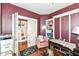 Comfortable bedroom featuring built-in storage, hardwood floors, and a cozy chair near the desk at 1217 Old Vines Trl, Greenwood, IN 46143
