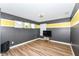 This bedroom features wood floors, and a yellow and grey accent wall at 1217 Old Vines Trl, Greenwood, IN 46143