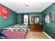 Cozy bedroom with green walls, dark curtains, and a wooden dresser for ample storage at 1217 Old Vines Trl, Greenwood, IN 46143