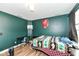 Bedroom showcasing green walls, desk area, and ample space for comfortable living at 1217 Old Vines Trl, Greenwood, IN 46143