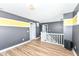 Hallway with wood floors, grey accent walls, and white trim at 1217 Old Vines Trl, Greenwood, IN 46143