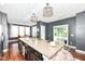 Modern kitchen featuring a center island with sink, dark wood cabinetry, stainless steel appliances, and hardwood floors at 1217 Old Vines Trl, Greenwood, IN 46143