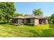 Back exterior view of home showing backyard, brick construction and lawn at 1220 Pintail Ct, Columbus, IN 47201