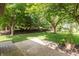 Lush backyard with mature trees and a tranquil garden, creating a private oasis at 1220 Pintail Ct, Columbus, IN 47201