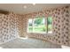 Inviting dining area with floral wallpaper, tile floors, and bright bay window overlooking the outdoor view at 1220 Pintail Ct, Columbus, IN 47201