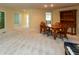 Dining room featuring neutral carpet, an oak table and chairs, and built-in shelving at 1220 Pintail Ct, Columbus, IN 47201