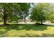 Home with mature trees, expansive lawn, and a welcoming front entrance at 1220 Pintail Ct, Columbus, IN 47201