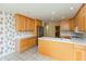 A traditional kitchen features wood cabinets, white countertops, and stainless steel appliances at 1220 Pintail Ct, Columbus, IN 47201