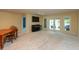 Spacious living room with neutral carpet, piano, dining table and patio access at 1220 Pintail Ct, Columbus, IN 47201
