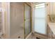 Close-up of a glass shower with gold frame and an adjacent window at 1220 Pintail Ct, Columbus, IN 47201