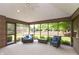 Bright sun room featuring neutral carpet, casual furniture and windows with wooded views at 1220 Pintail Ct, Columbus, IN 47201