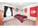 Red and white themed bedroom with natural light and carpeted floors at 13068 Lamarque Pl, Fishers, IN 46038