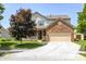 Charming two-story home boasts a brick-and-vinyl facade, well-manicured lawn, and an attached two-car garage at 13068 Lamarque Pl, Fishers, IN 46038