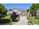 Charming two-story home featuring brick accents, mature trees, and a well-manicured lawn at 13068 Lamarque Pl, Fishers, IN 46038