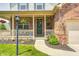 Inviting front porch with brick accents, decorative plants, and a welcoming entrance at 13068 Lamarque Pl, Fishers, IN 46038