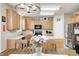 Eat-in kitchen with wood cabinets, stainless steel appliances, and dining area creates a warm and inviting space at 13068 Lamarque Pl, Fishers, IN 46038
