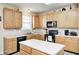 Bright kitchen features wooden cabinetry, white countertops, and black appliances at 13068 Lamarque Pl, Fishers, IN 46038