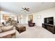 Spacious living room features neutral walls and carpet with a view into the kitchen and dining area at 13068 Lamarque Pl, Fishers, IN 46038